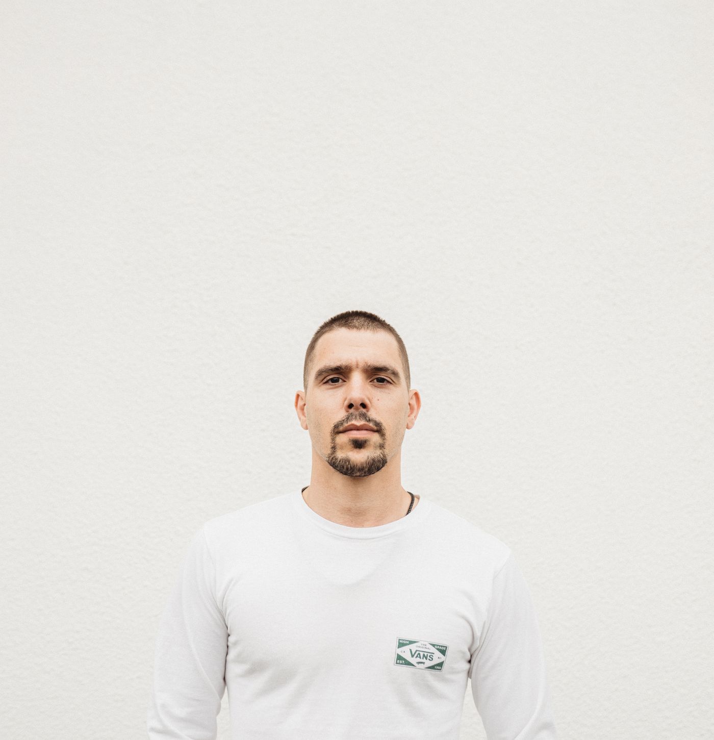 Unobstructed portrait of an adult man in a white shirt