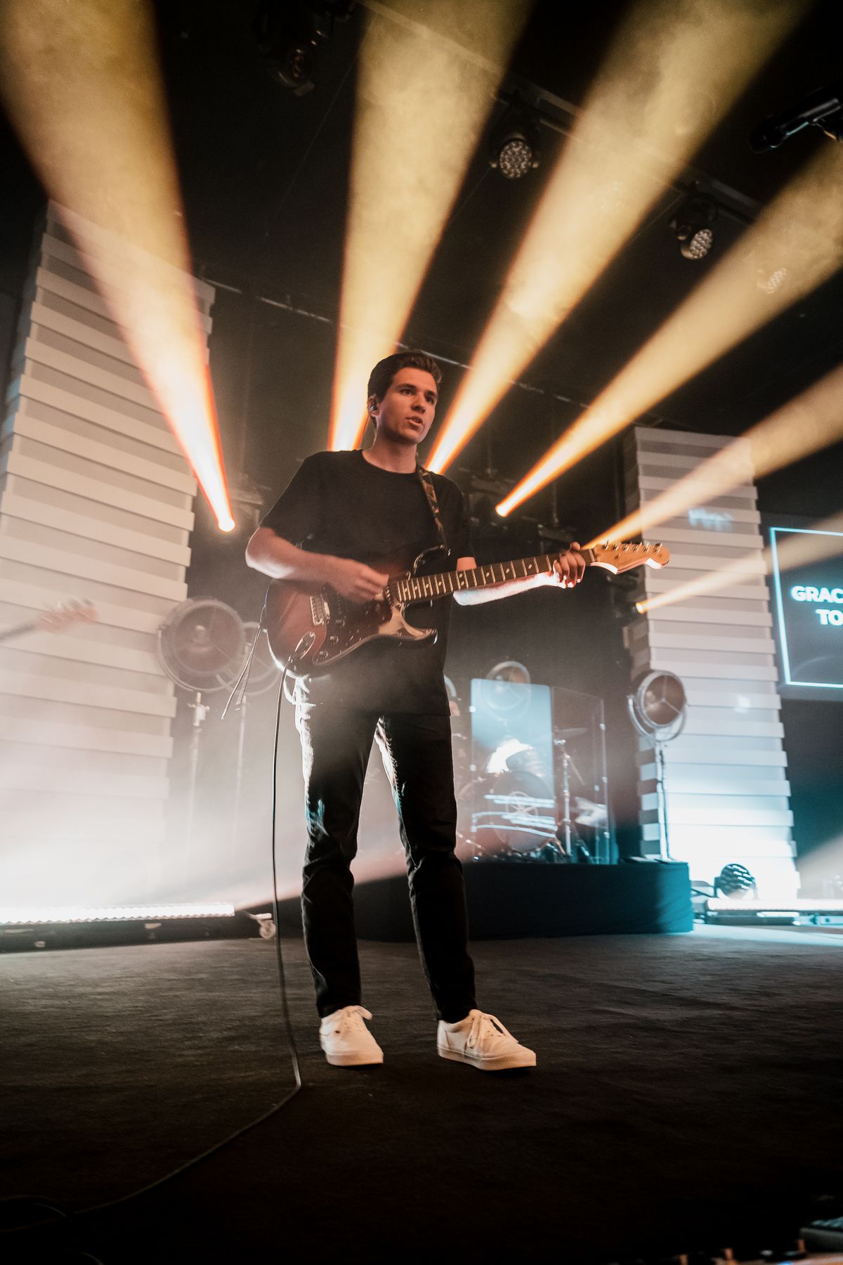 Guitarist performing on a concert stage