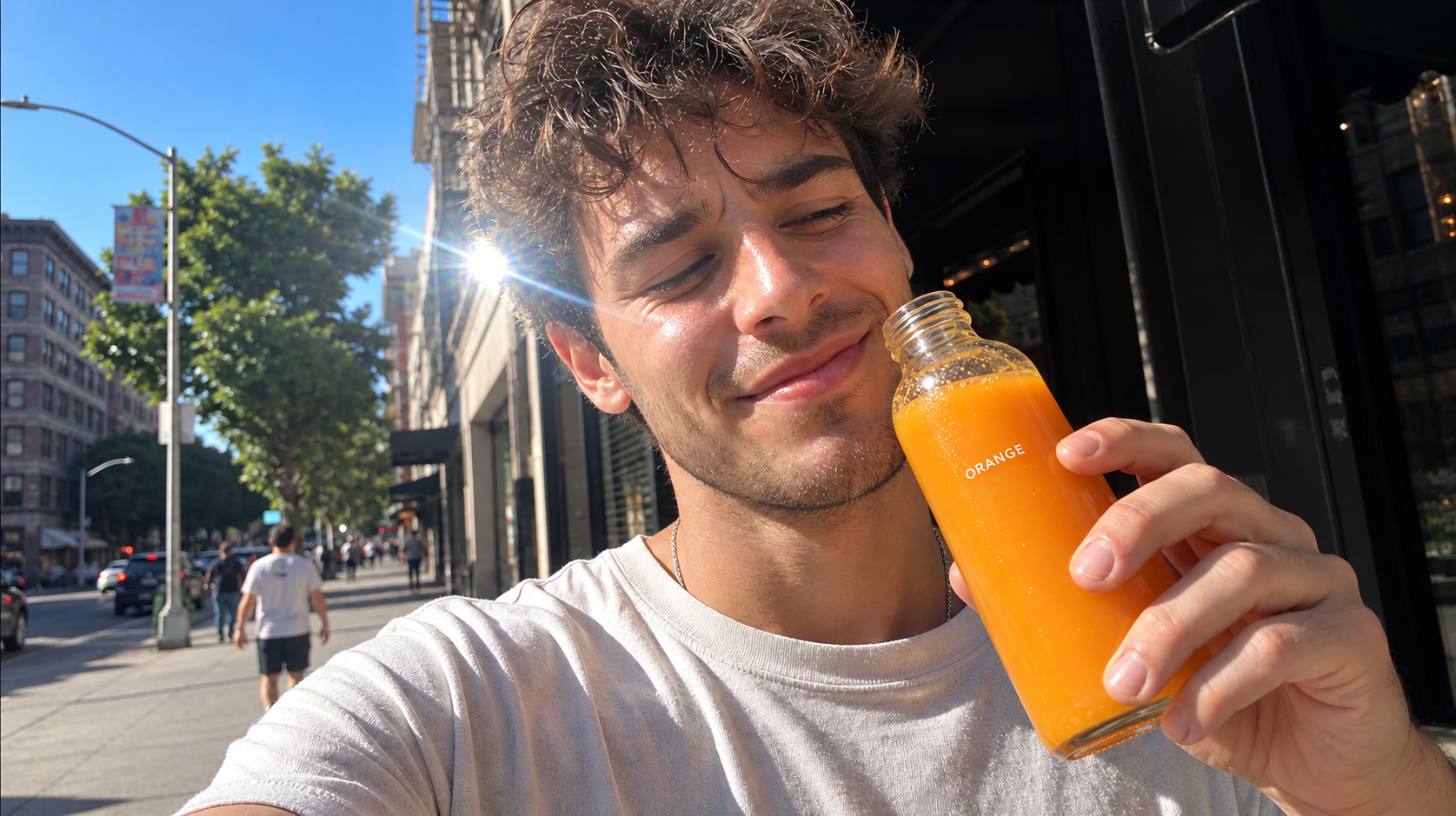 Man holding an orange drink